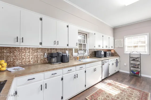 a kitchen with granite countertop white cabinets and white appliances