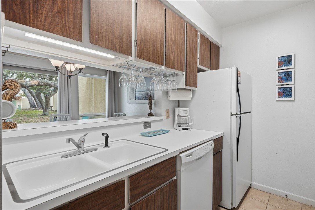 2003 North Fulton Beach Road, Unit 34 34 Rockport, TX 78382 - Photo 9 of 38 a kitchen with stainless steel appliances a sink and a refrigerator