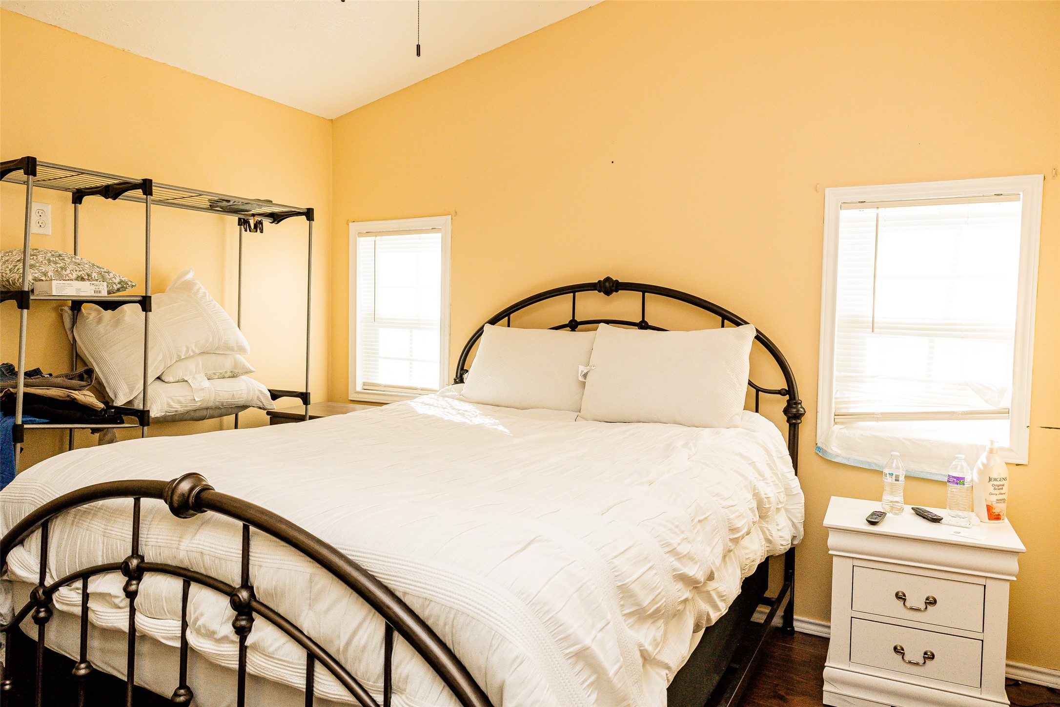 8608 Captain Scott Road Brenham, TX 77833 - Photo 25 of 28 a bedroom with a bed a dresser next to a window