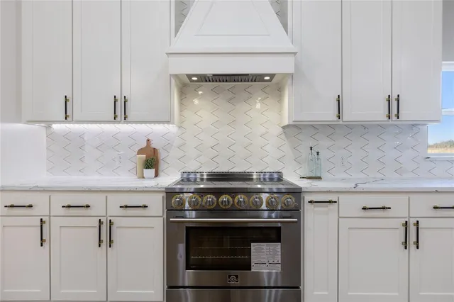 a stove top oven sitting inside of a kitchen