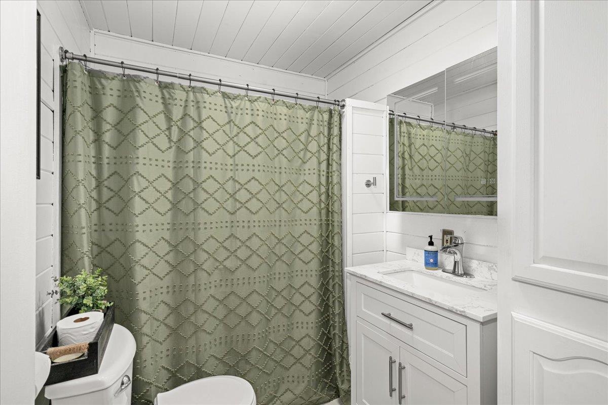 645 Stanley Road Two Harbors, MN 55616 - Photo 11 of 26 Full bath with vanity and curtained shower