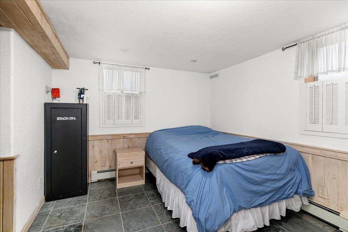 645 Stanley Road Two Harbors, MN 55616 - Photo 14 of 26 Bedroom featuring a textured ceiling, a baseboard radiator, and baseboard heating