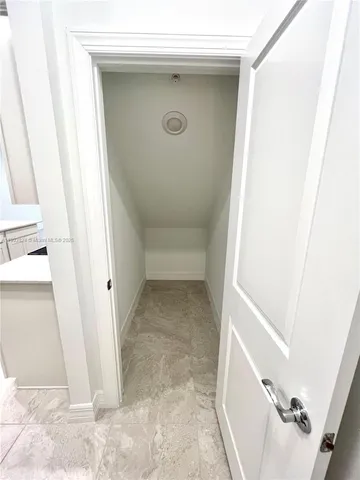 a view of kitchen and hall with wooden floor