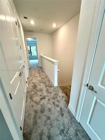 a bathroom with a wooden floor and shower