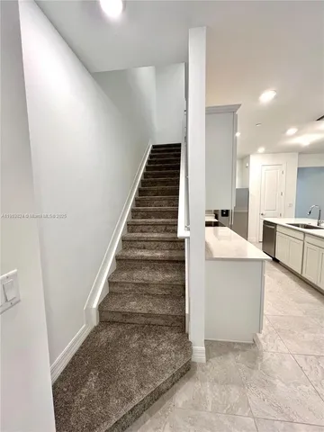 a white toilet sitting next to a shower