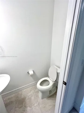 a view of a hallway with a livingroom and a hall with wooden floor