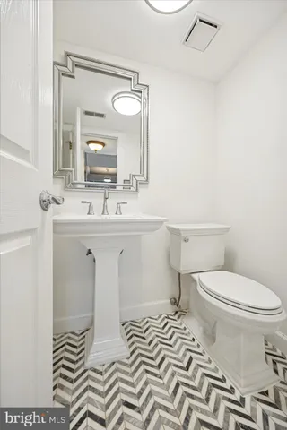 a spacious bathroom with a granite countertop sink a mirror and a shower