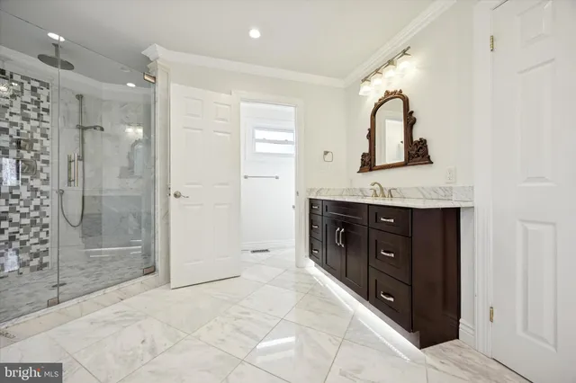 a spacious bathroom with a granite countertop sink mirror and