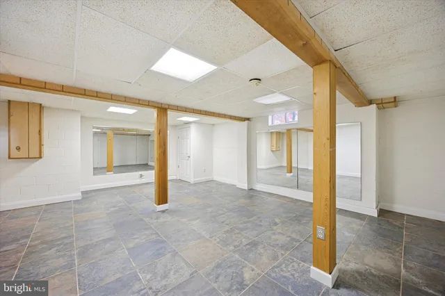 a view of a street with a bench and trees