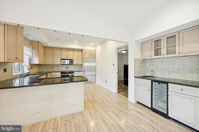 a kitchen with stainless steel appliances granite countertop a stove and a refrigerator