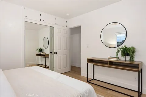 a bedroom with a bed and a mirror