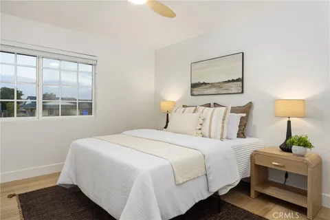 a bedroom with a bed lamp and a window