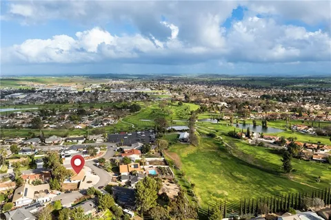 an aerial view of residential houses with outdoor space and trees