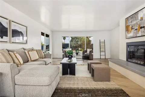 a living room with furniture large window and a fireplace