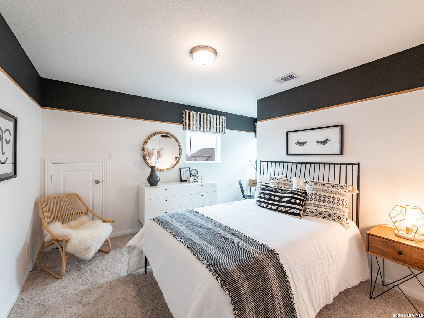 10715 Upwind Turn Converse, TX 78109 - Photo 15 of 17 a bedroom with a bed and a lamp on dresser with wooden floor