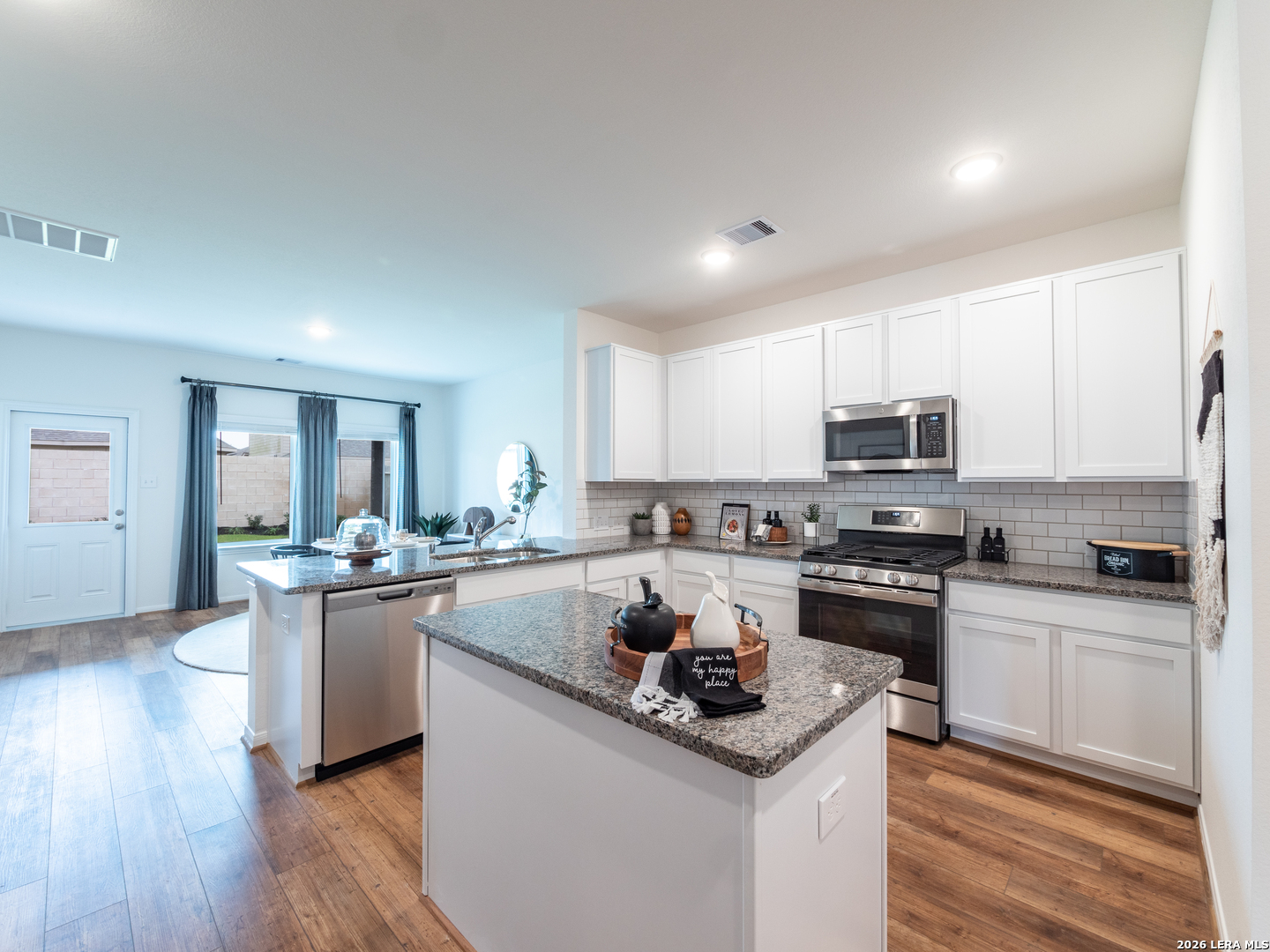 10715 Upwind Turn Converse, TX 78109 - Photo 6 of 17 a kitchen with stainless steel appliances a sink stove top oven and cabinets