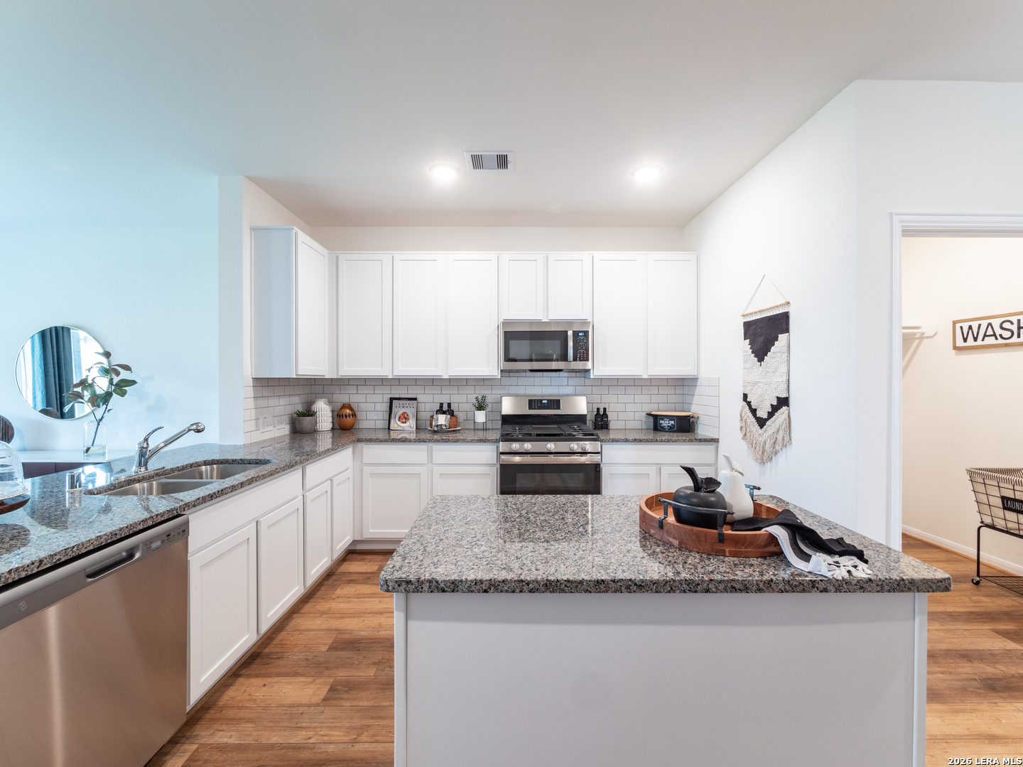 10715 Upwind Turn Converse, TX 78109 - Photo 7 of 17 a kitchen with sink a stove and cabinets