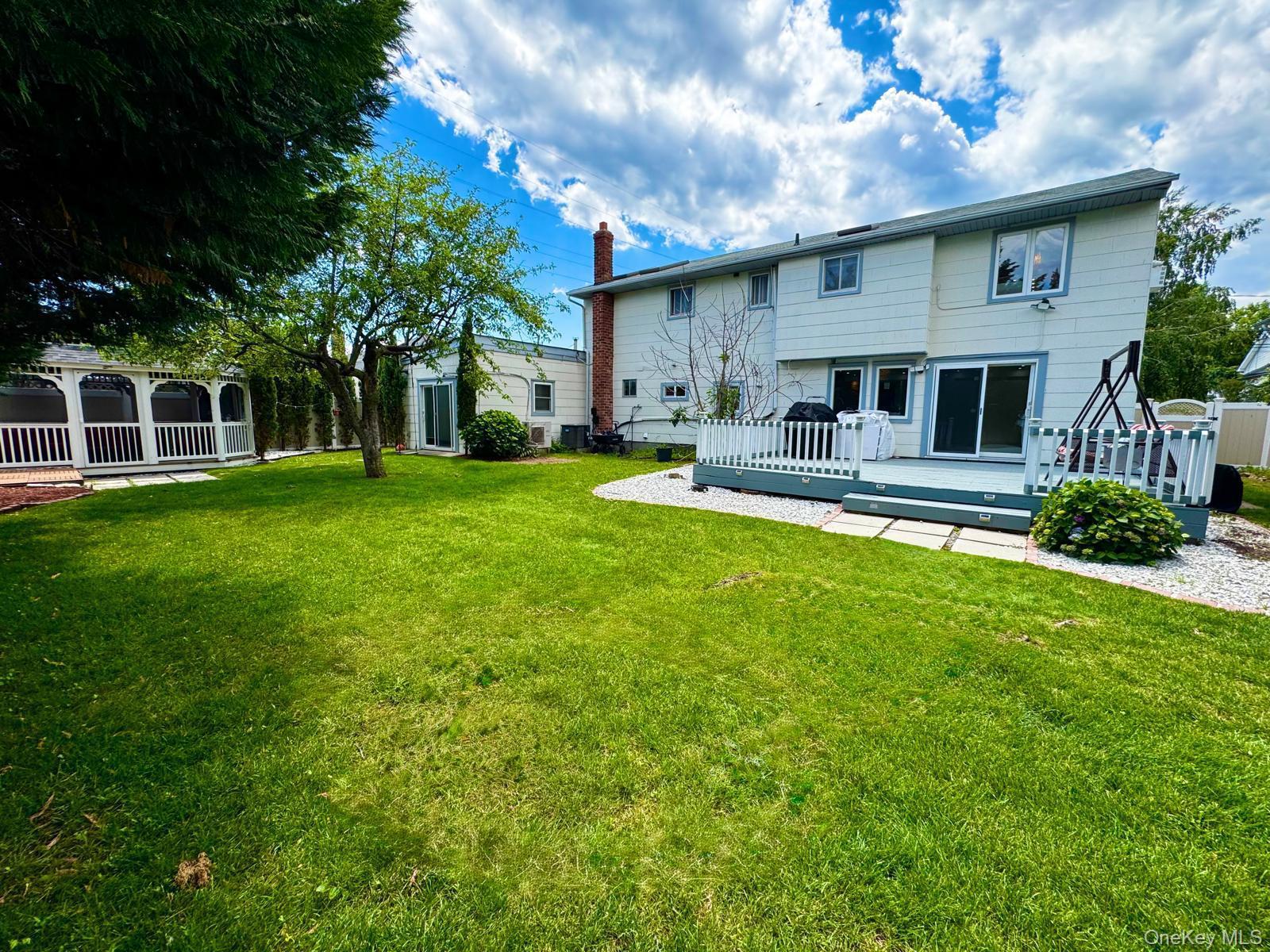 62 Walnut Road Inwood, NY 11096 - Photo 5 of 27 front view of a house with a yard
