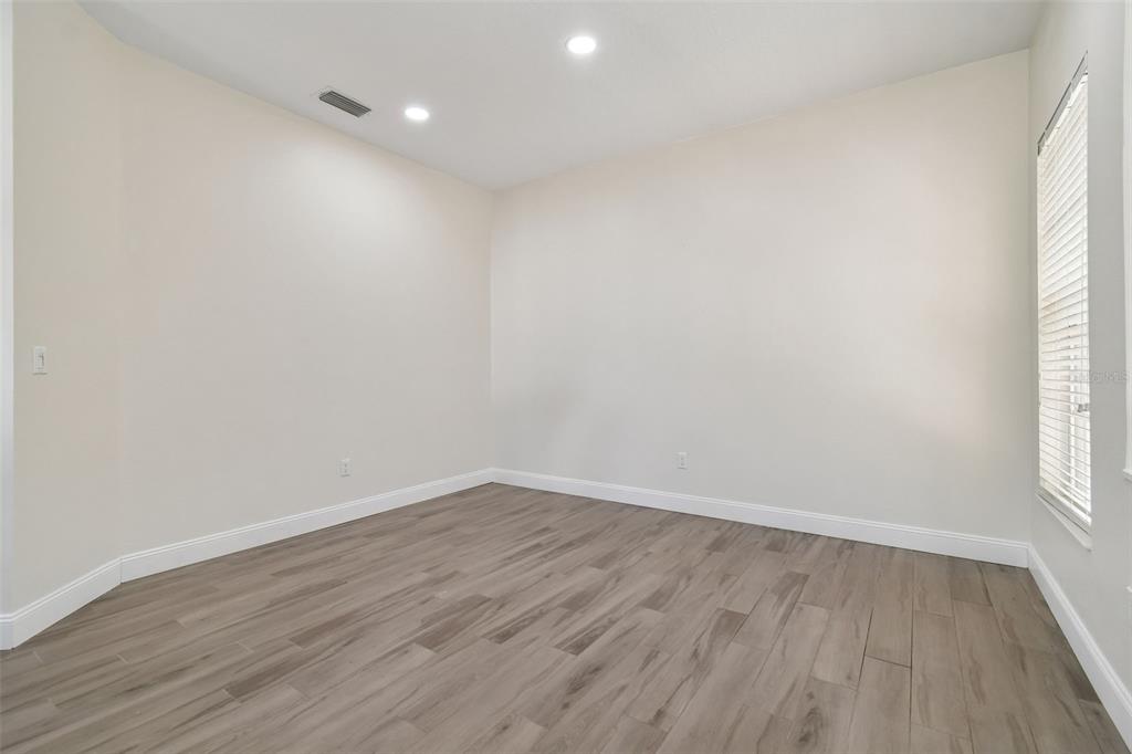 3311 Stonebridge Trail Valrico, FL 33596 - Photo 12 of 33 wooden floor in an empty room with a window