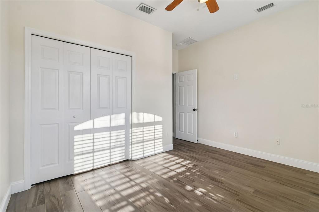 3311 Stonebridge Trail Valrico, FL 33596 - Photo 16 of 33 an empty room with wooden floor and windows