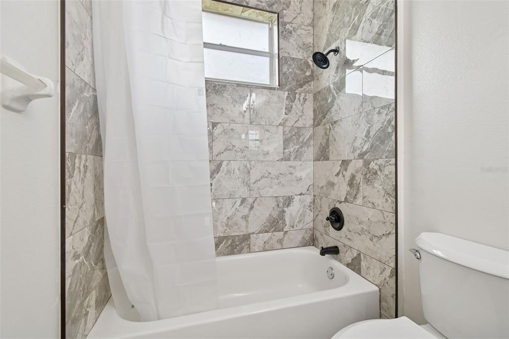 3311 Stonebridge Trail Valrico, FL 33596 - Photo 18 of 33 a bathroom with a bathtub and a shower