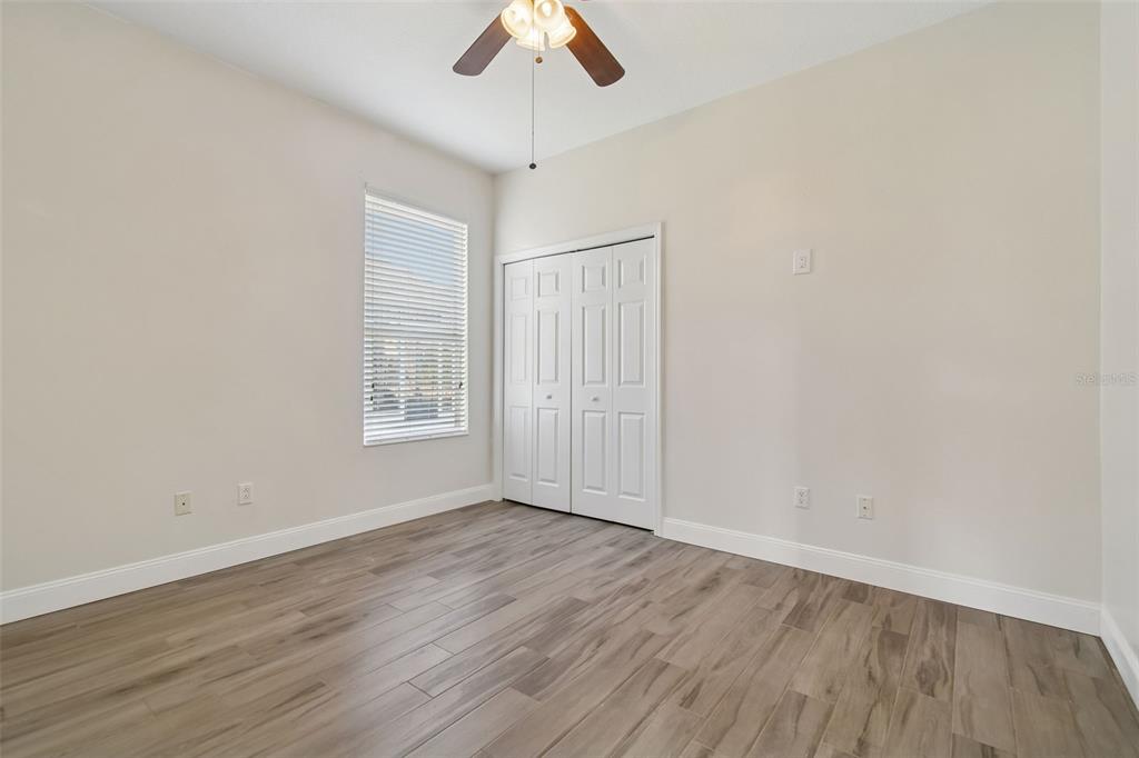 3311 Stonebridge Trail Valrico, FL 33596 - Photo 19 of 33 wooden floor in an empty room with a window