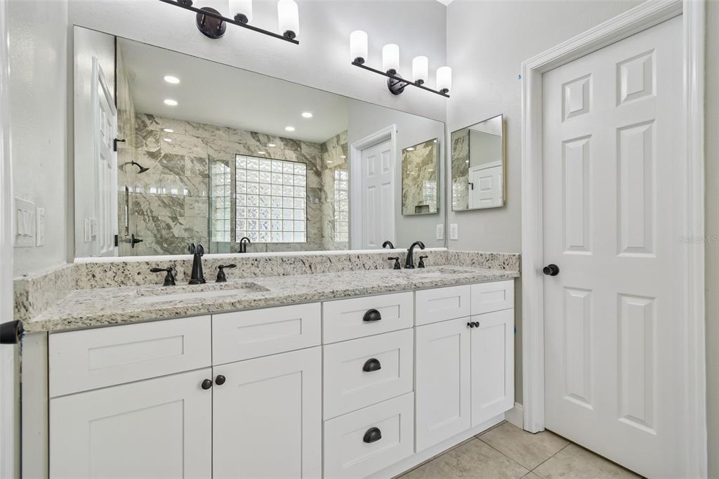 3311 Stonebridge Trail Valrico, FL 33596 - Photo 22 of 33 a bathroom with double sink and a mirror