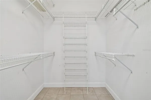 a view of walk in closet with empty racks