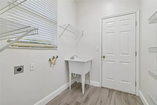 a view of a hallway with wooden floor and a cabinet