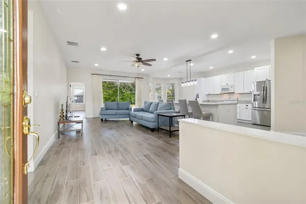a living room with furniture and a wooden floor