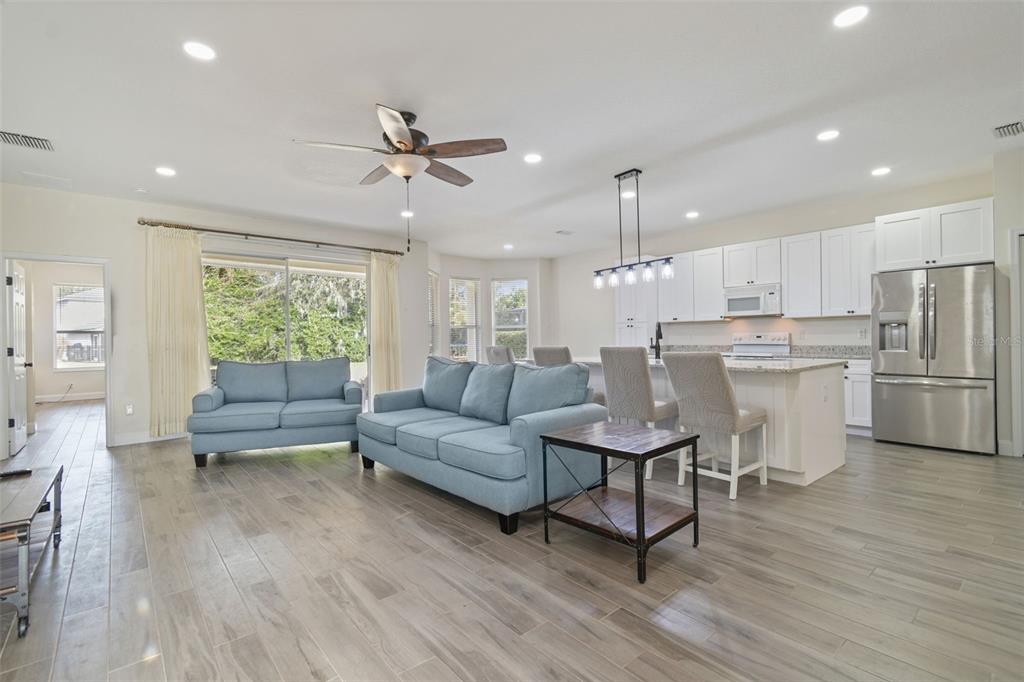 3311 Stonebridge Trail Valrico, FL 33596 - Photo 6 of 33 a living room with furniture and kitchen view