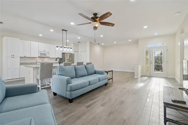 a living room with furniture and kitchen view