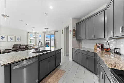 a kitchen with stainless steel appliances granite countertop a sink stove and cabinets