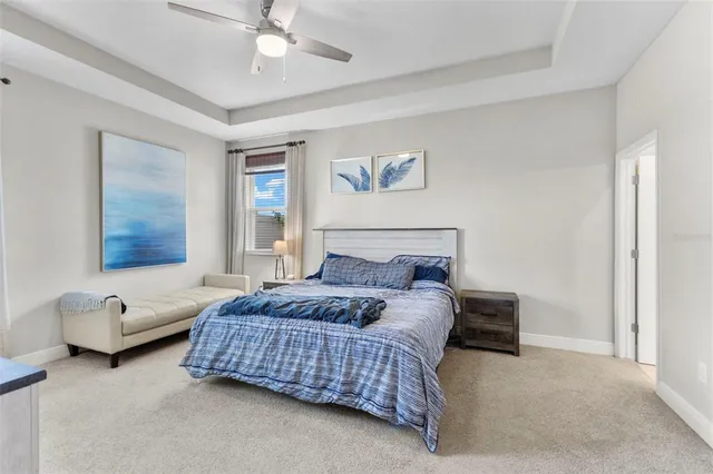 a bedroom with a bed couch and window