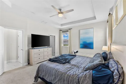 a bedroom with a bed a television and dresser