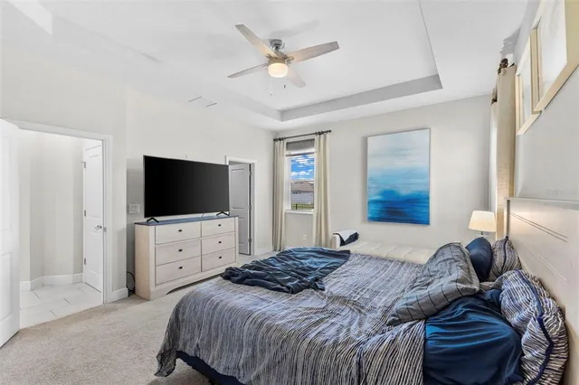 a bedroom with a bed a television and dresser