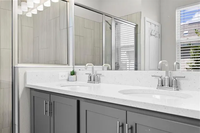 a bathroom with a double vanity sink and a mirror