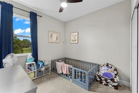 a bedroom with furniture and a large window