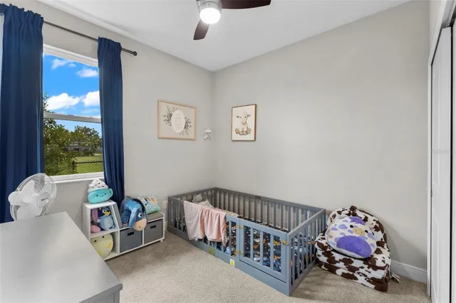 a bedroom with furniture and a large window
