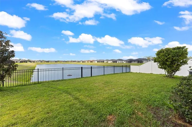 a view of a lake with houses in the back