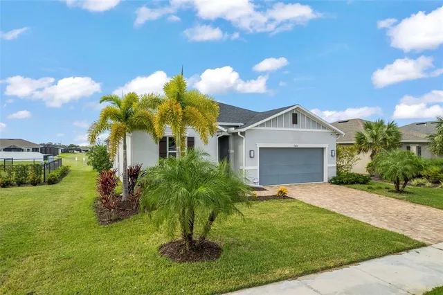 a front view of a house with a yard and garage
