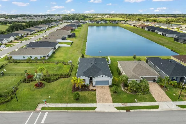 an aerial view of residential houses with outdoor space and river