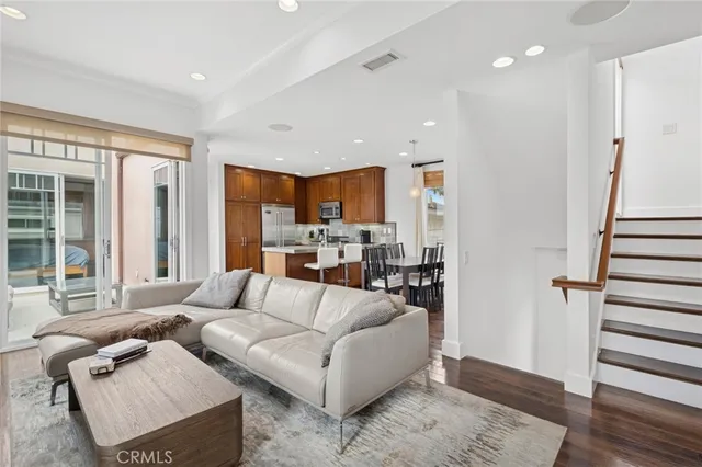 a kitchen with granite countertop a stove a sink and a refrigerator