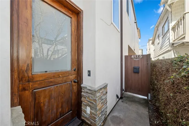 a view of staircase with wooden floor and white walls