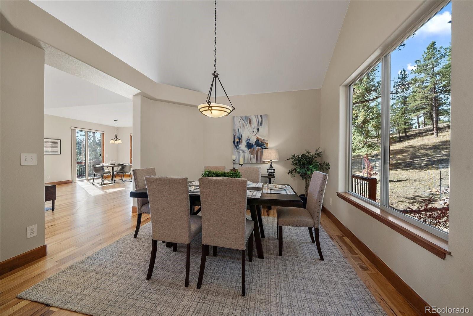 28857 Cedar Circle Evergreen, CO 80439 - Photo 11 of 50 a view of a dining room with furniture window and wooden floor