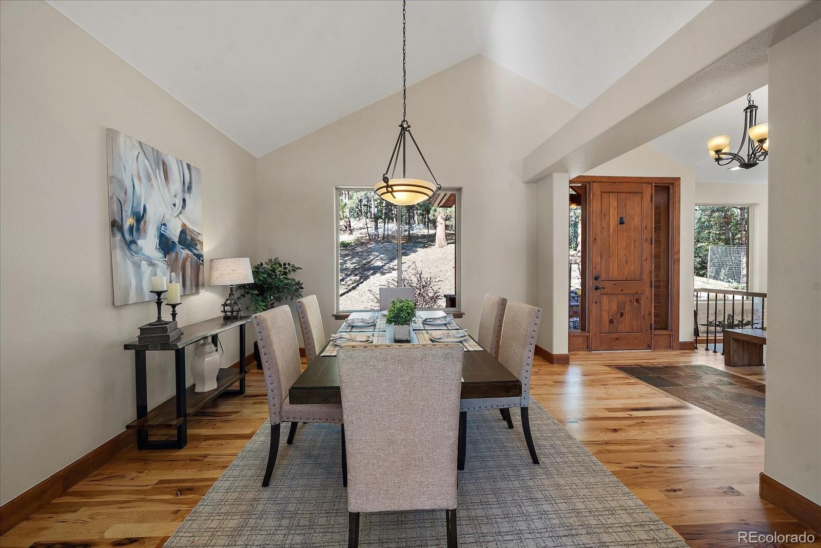 28857 Cedar Circle Evergreen, CO 80439 - Photo 12 of 50 a view of a dining room with furniture window and wooden floor