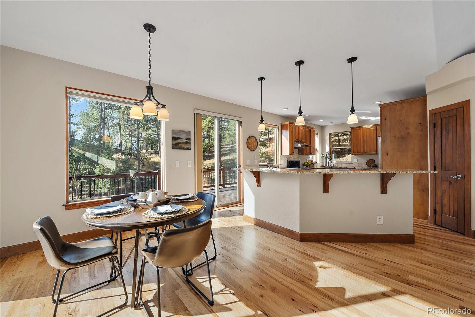 28857 Cedar Circle Evergreen, CO 80439 - Photo 14 of 50 a dining room with furniture and wooden floor