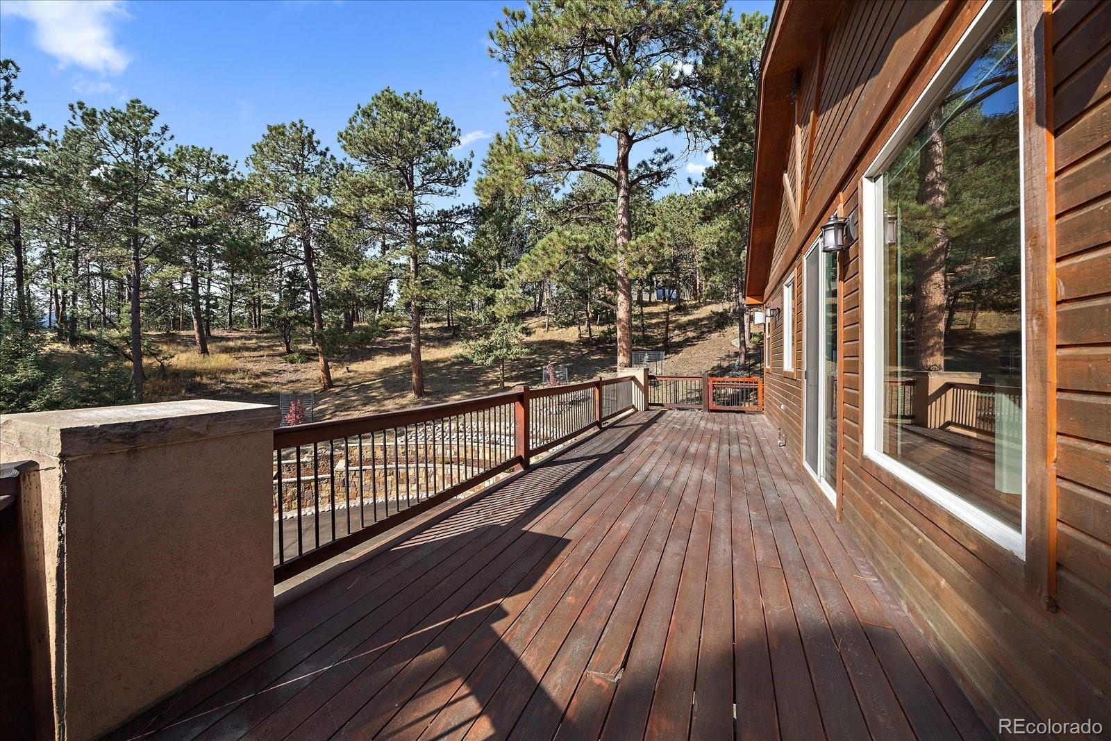 28857 Cedar Circle Evergreen, CO 80439 - Photo 39 of 50 a view of a balcony with wooden floor and outdoor space