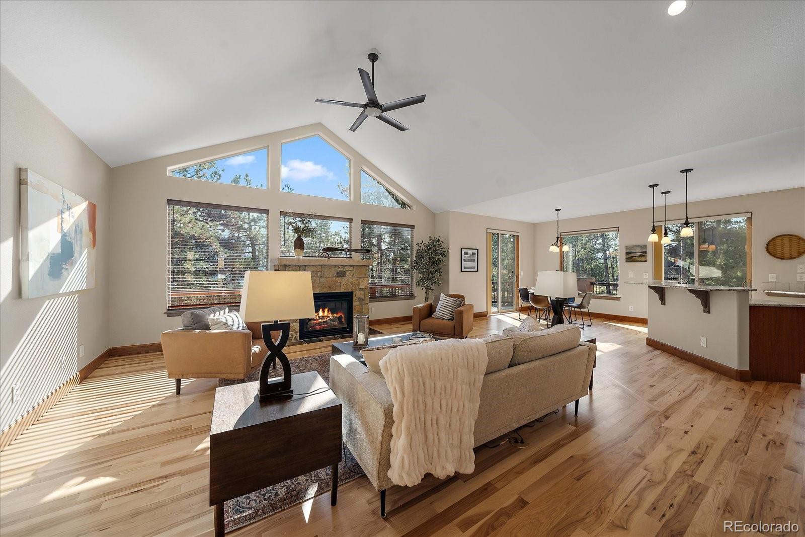28857 Cedar Circle Evergreen, CO 80439 - Photo 8 of 50 a living room with fireplace furniture and a large window