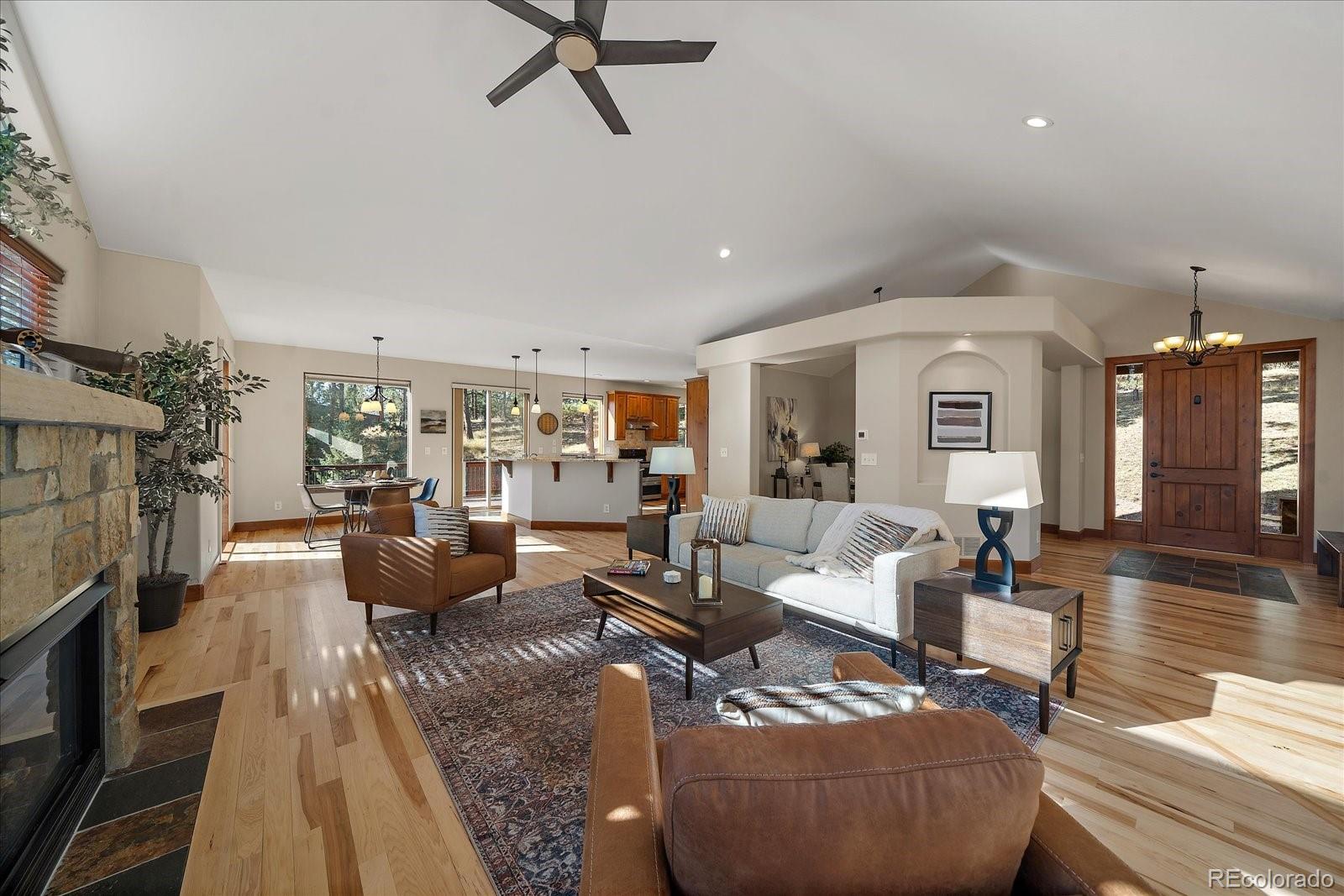 28857 Cedar Circle Evergreen, CO 80439 - Photo 10 of 50 a living room with furniture and a fireplace
